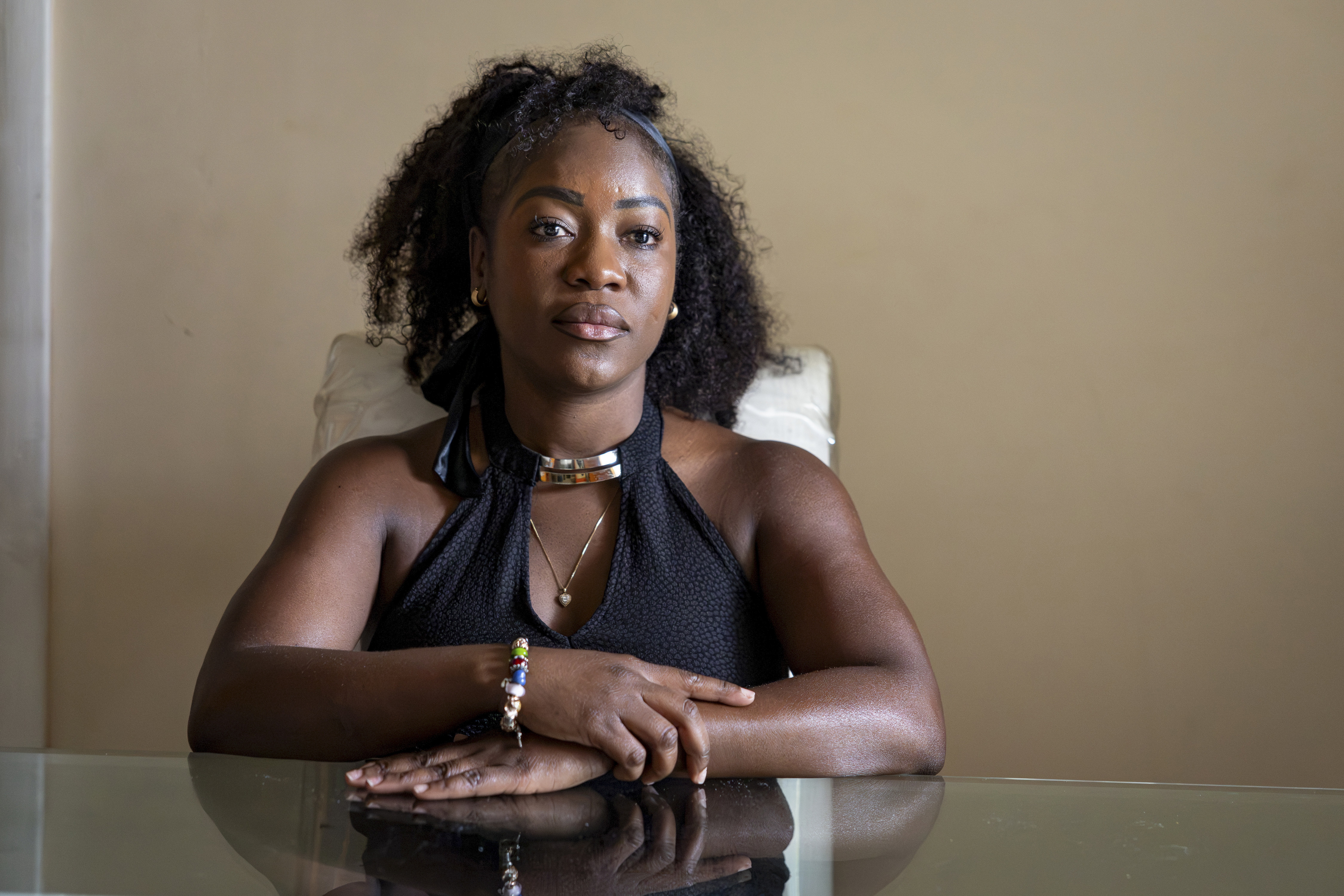 Herlain, who asked NPR to withhold her last name, poses for a portrait at her home in North Lauderdale, Fla. She is a registered nurse from Haiti who recently lost her temporary protected status, or TPS.